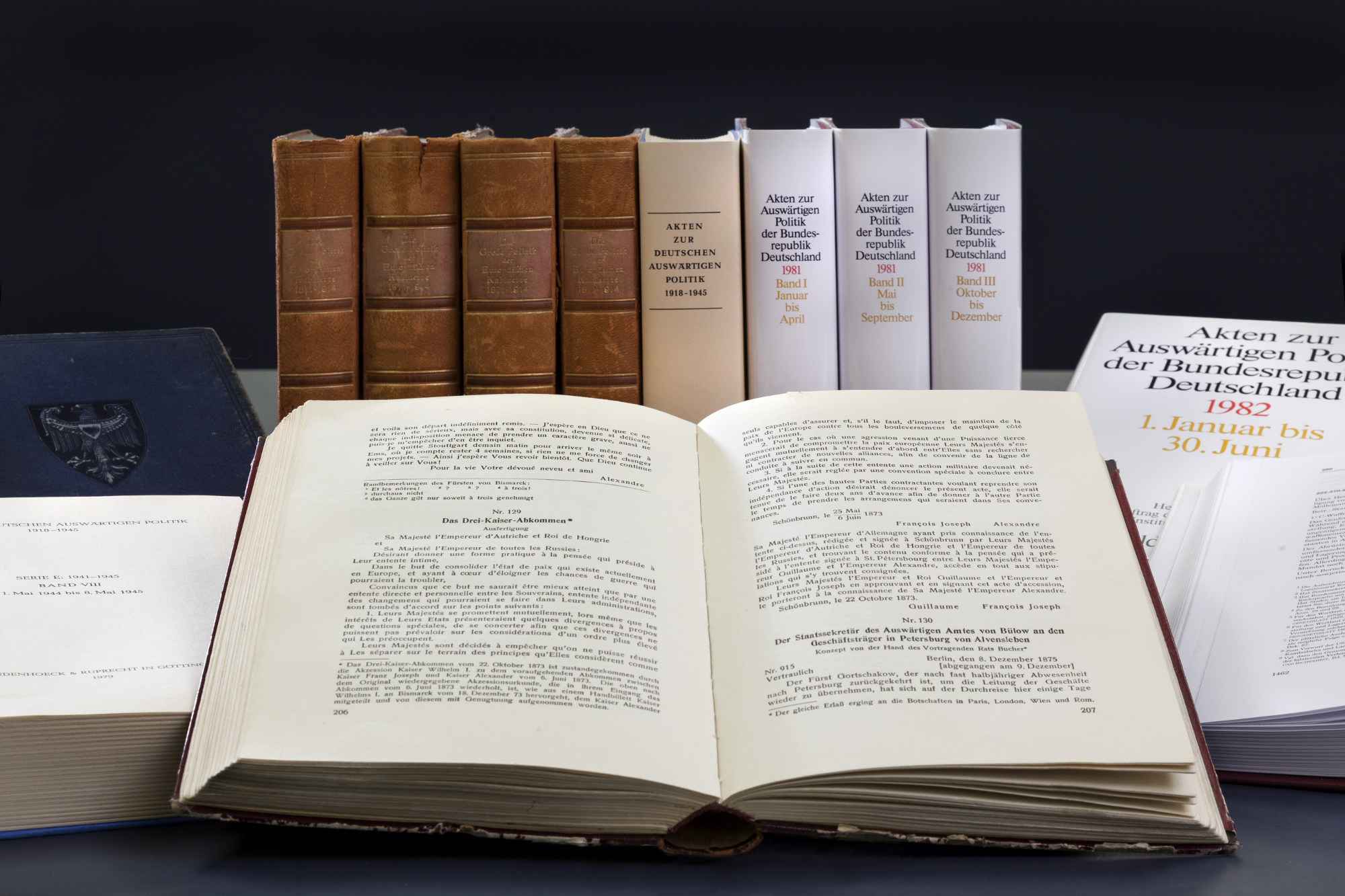 aufgeschlagenes Exemplar der Aktenedition „Akten zur Auswärtigen Politik der Bundesrepublik Deutschland“, dahinter stehen und liegen weitere Exemplare